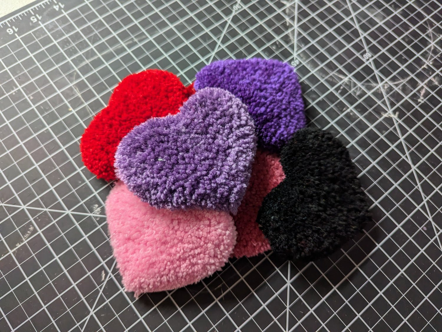 A small pile of heart wrist rest rugs